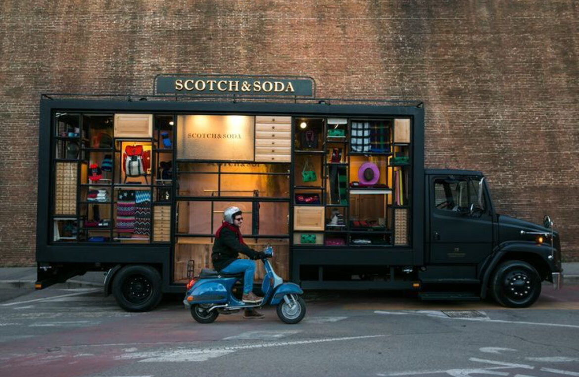 Scotch & Soda mobile retail activation showing a branded truck and scooter outside a brick building.